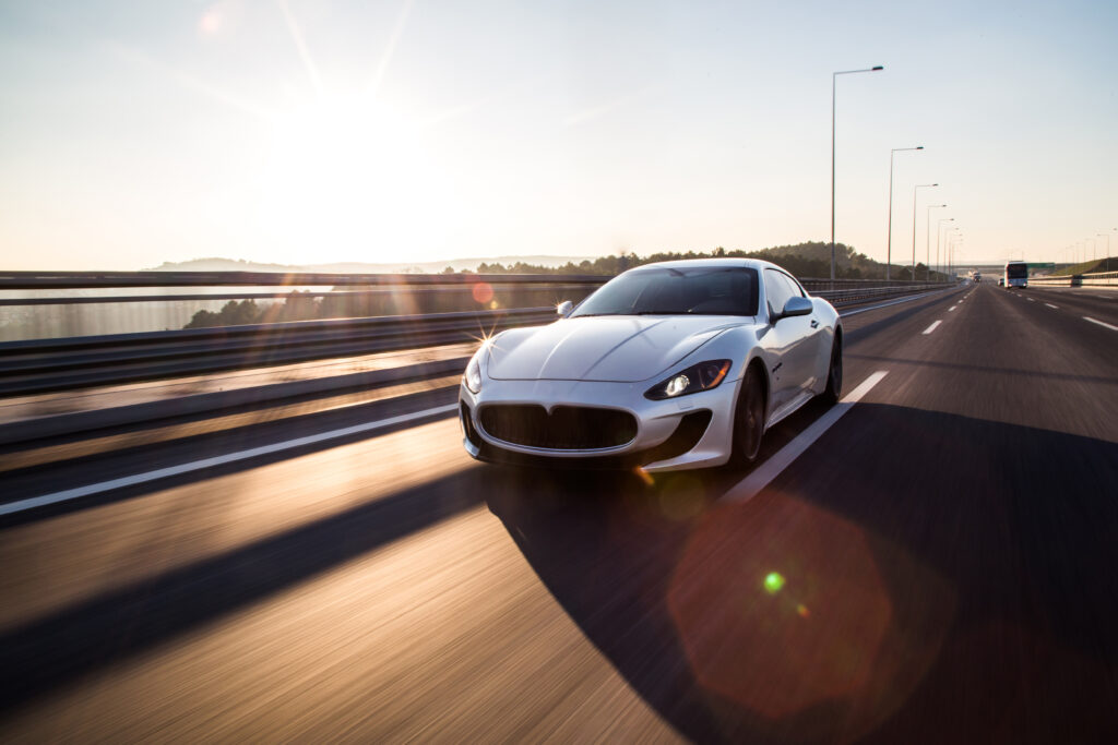 A luxury sports car travelling on a highway